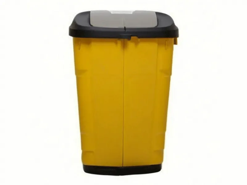 A yellow waste bin with a black lid.