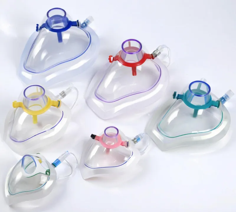 Collection of colored anesthesia masks on a white background.