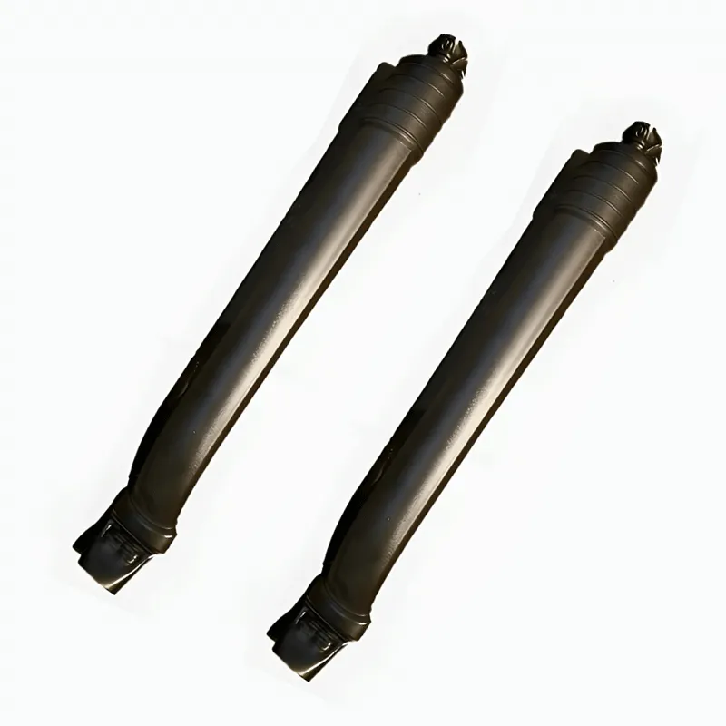 Two black shock absorbers on a white background.