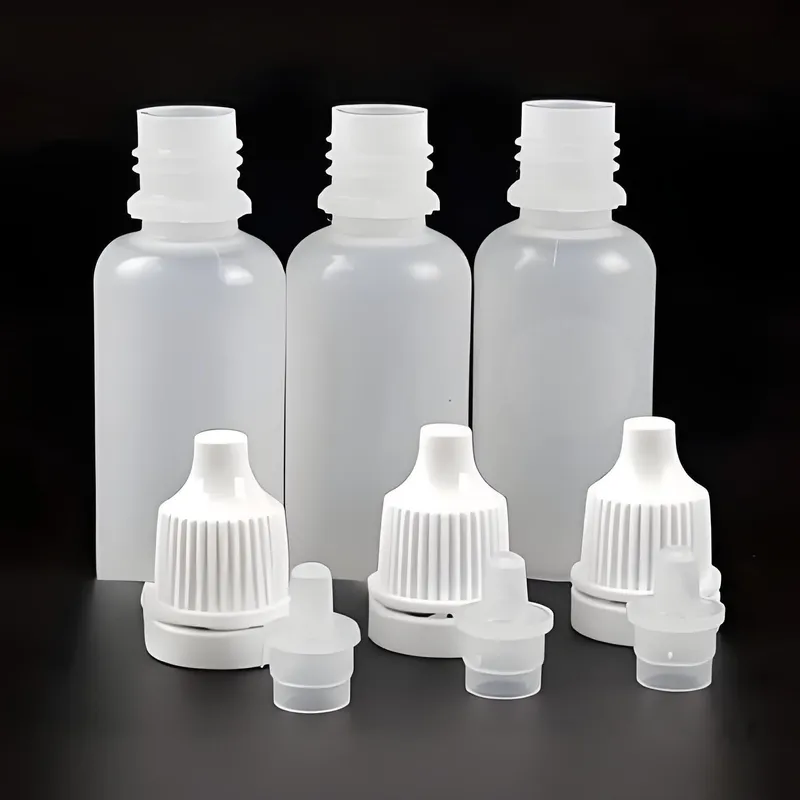 Three empty plastic bottles with separate white caps and nozzles.