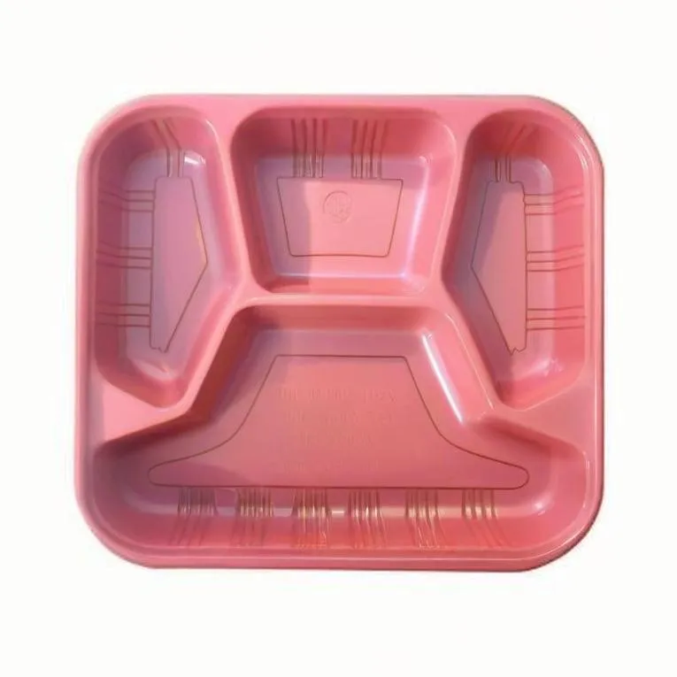 A pink plastic tray with several compartments for holding different types of food.