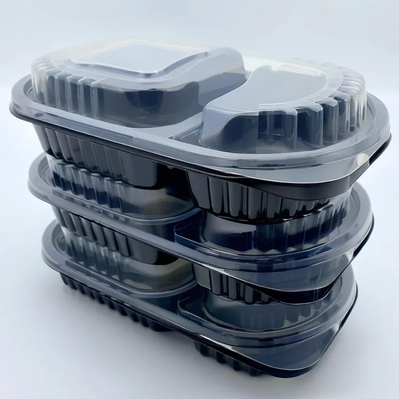 A stack of four black plastic meal prep containers with clear lids.