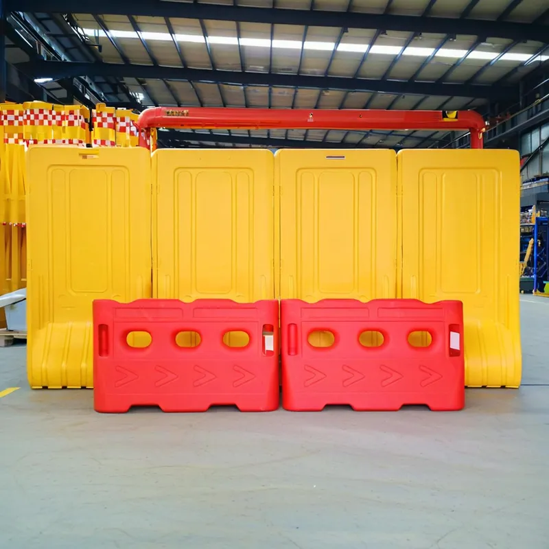 Red and yellow plastic traffic barriers arranged in a warehouse.
