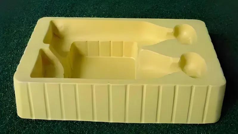 A yellow molded tray with compartments designed to hold specific items