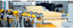 An image of industrial machinery with rollers and yellow components.