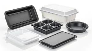 Various black and white food containers and trays in different shapes and sizes.