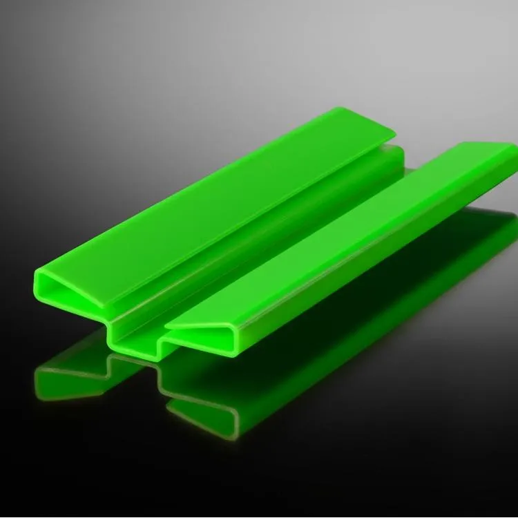 An image of a green plastic Long Walkway Joint Connector against a reflective dark surface.