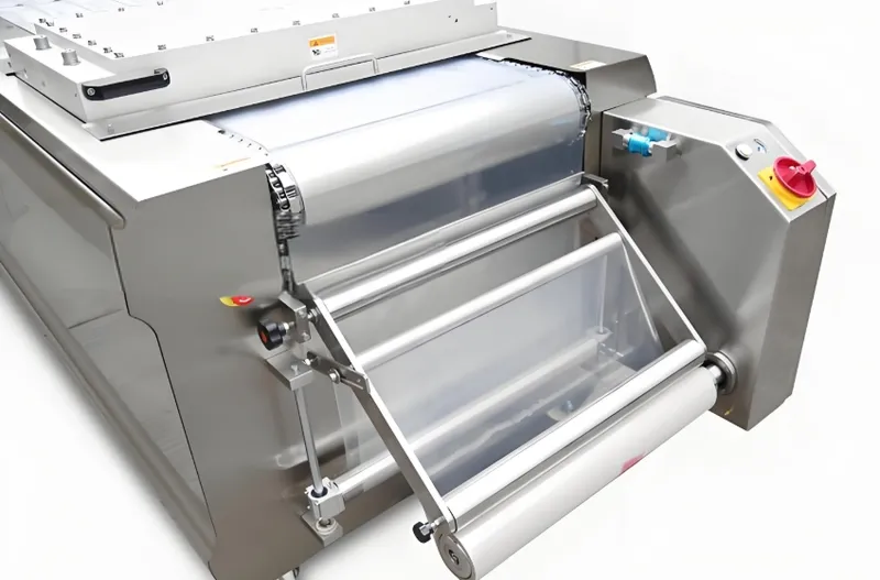 A commercial dough roller machine with steel rollers for flattening dough