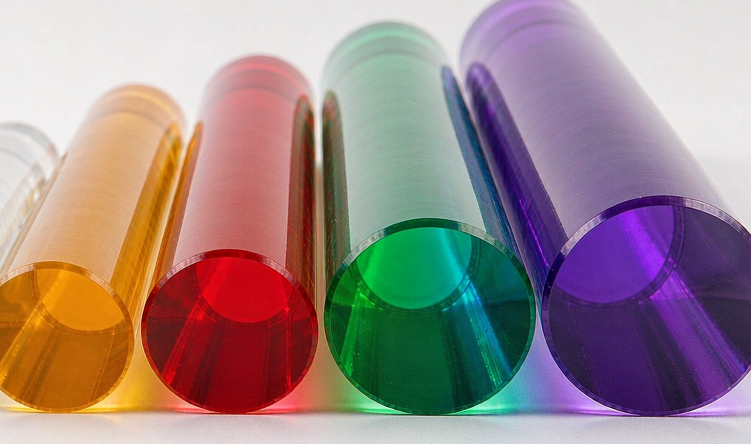Solid transparent acrylic rods in amber, red, green and violet, diameters stepping up from 10 mm to 40 mm