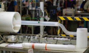 Quality control bench with a laser diameter gauge, calipers and inspection records on a profile line