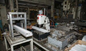 Punch press and milling station used for secondary operations on extruded plastic profiles