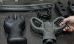 Black and grey TPE and TPU injection moulded soft grip handles and seals on a workshop bench