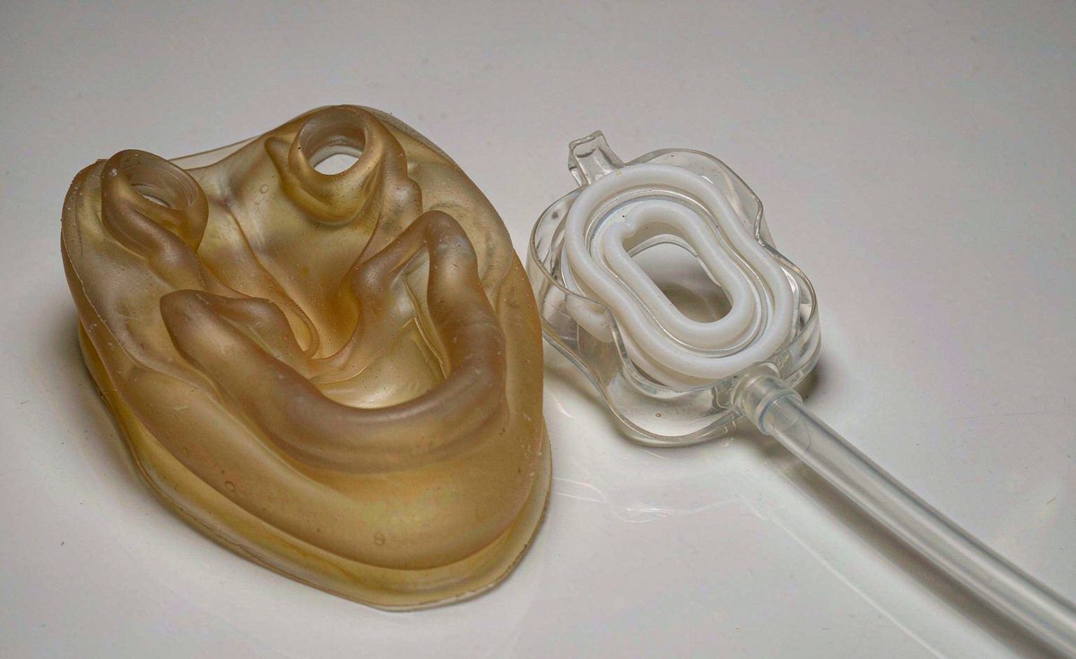 Medical grade silicone mask cushion, seal and clear silicone tubing on a clinical surface